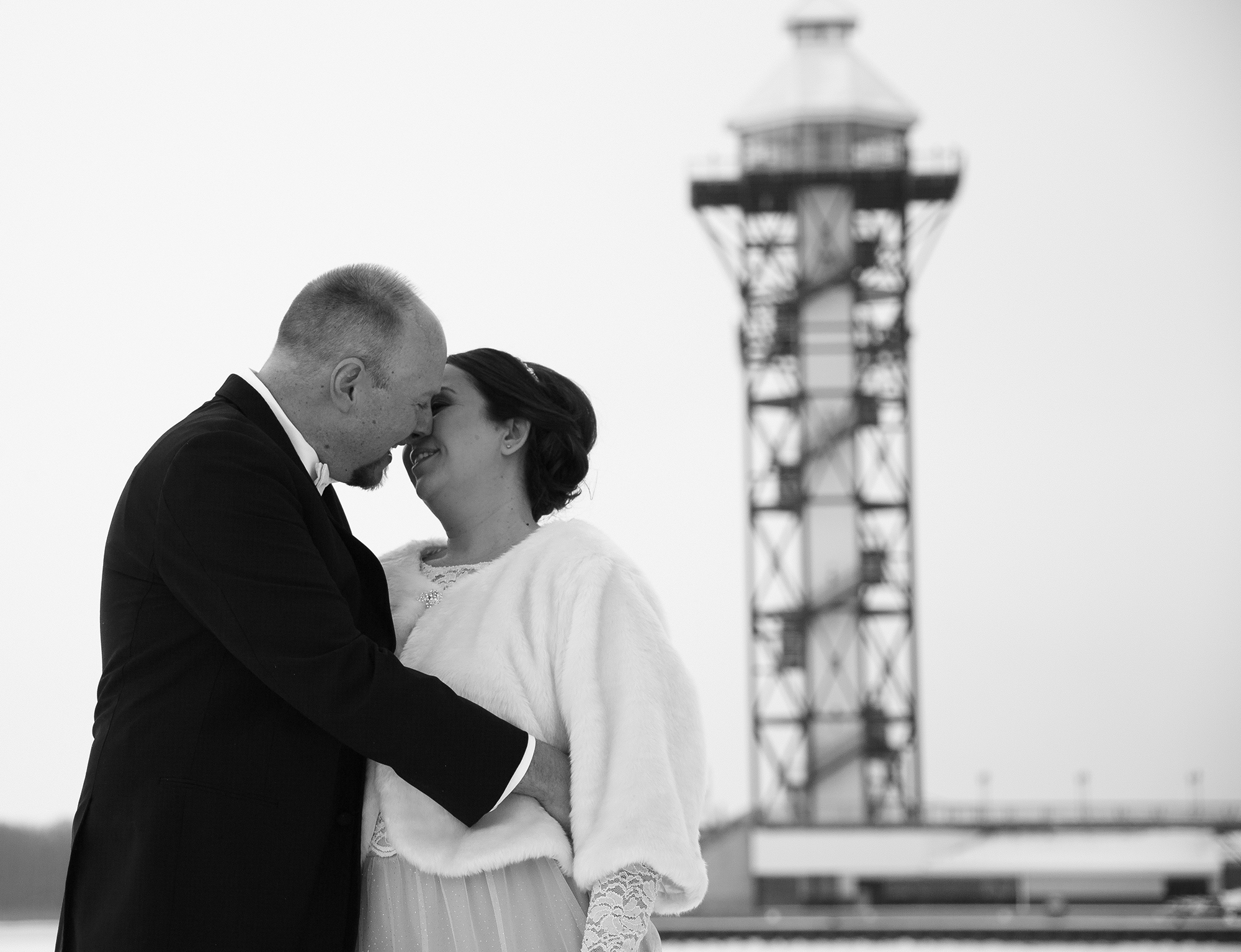 bride and groom about to kiss in front of Bicentennial Tower at their Sheraton Bayfront hotel wedding in Erie, PA