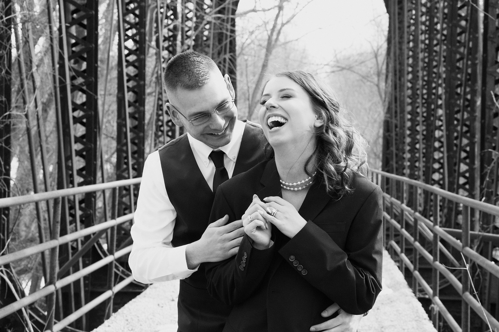 bride and groom laughing during wedding portrait session at the Barn at Conneaut CReek