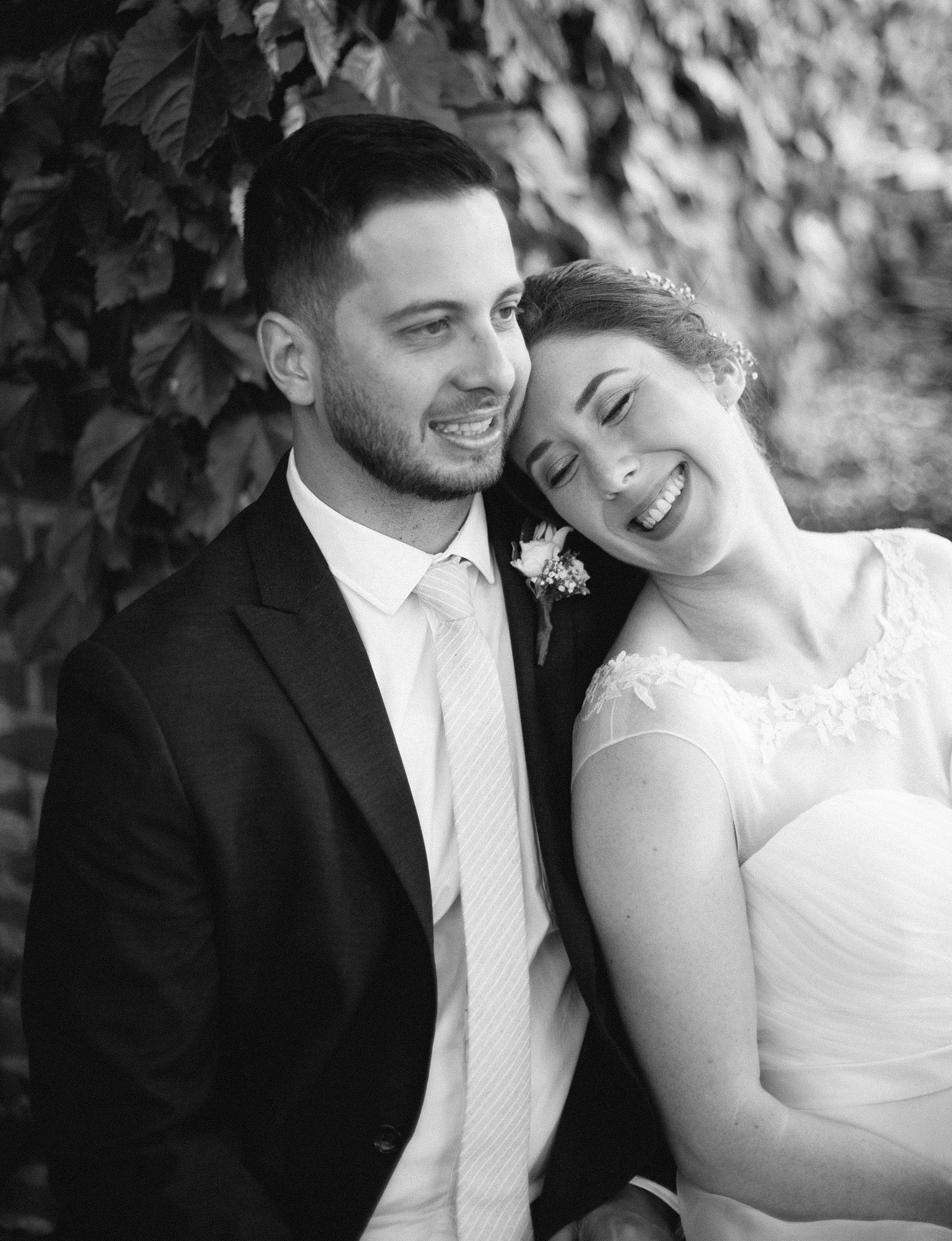 bride leans on groom's shoulder at Pittsburgh National Aviary wedding