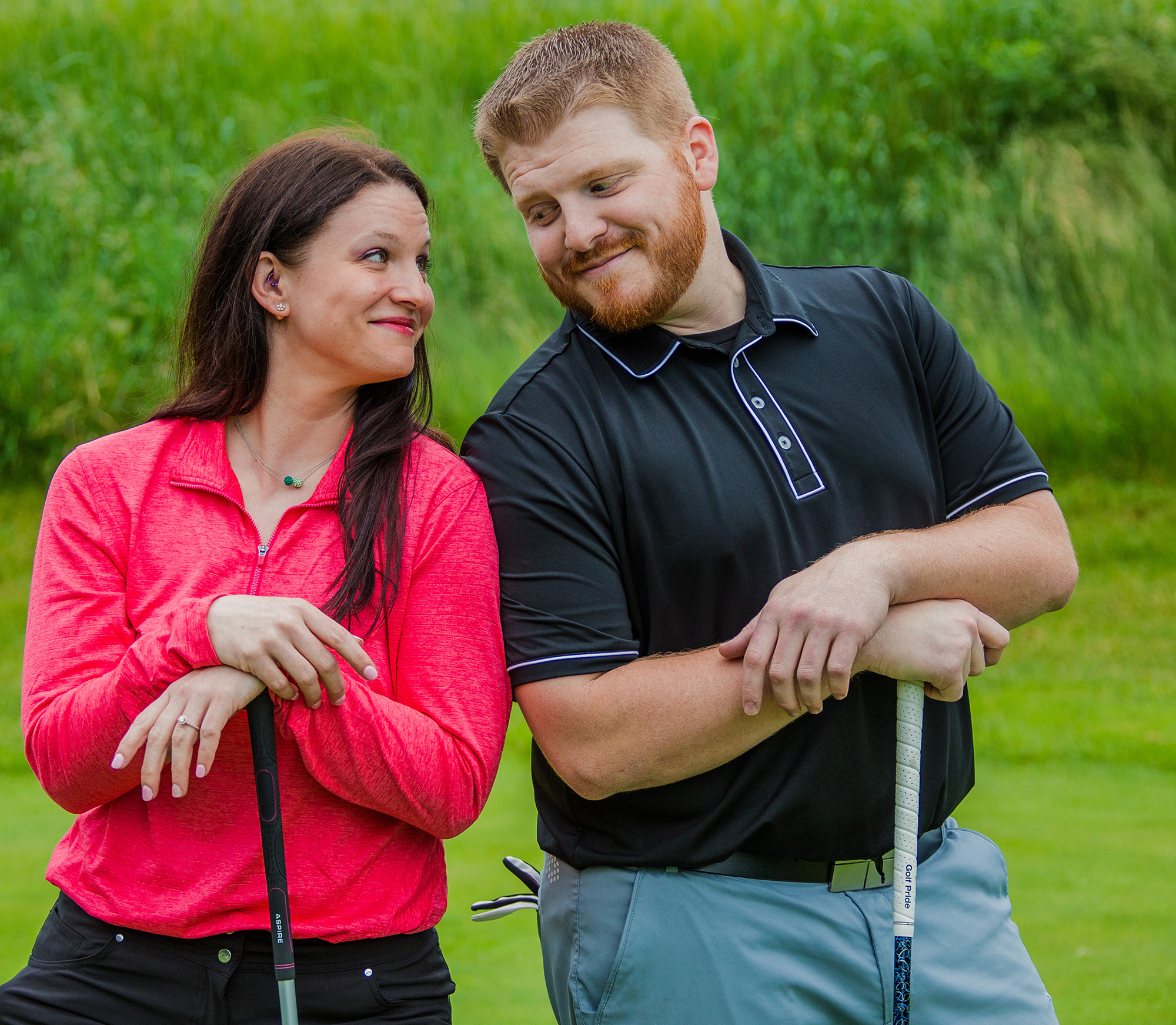 couple smiling during Whispering Woods engagement photos