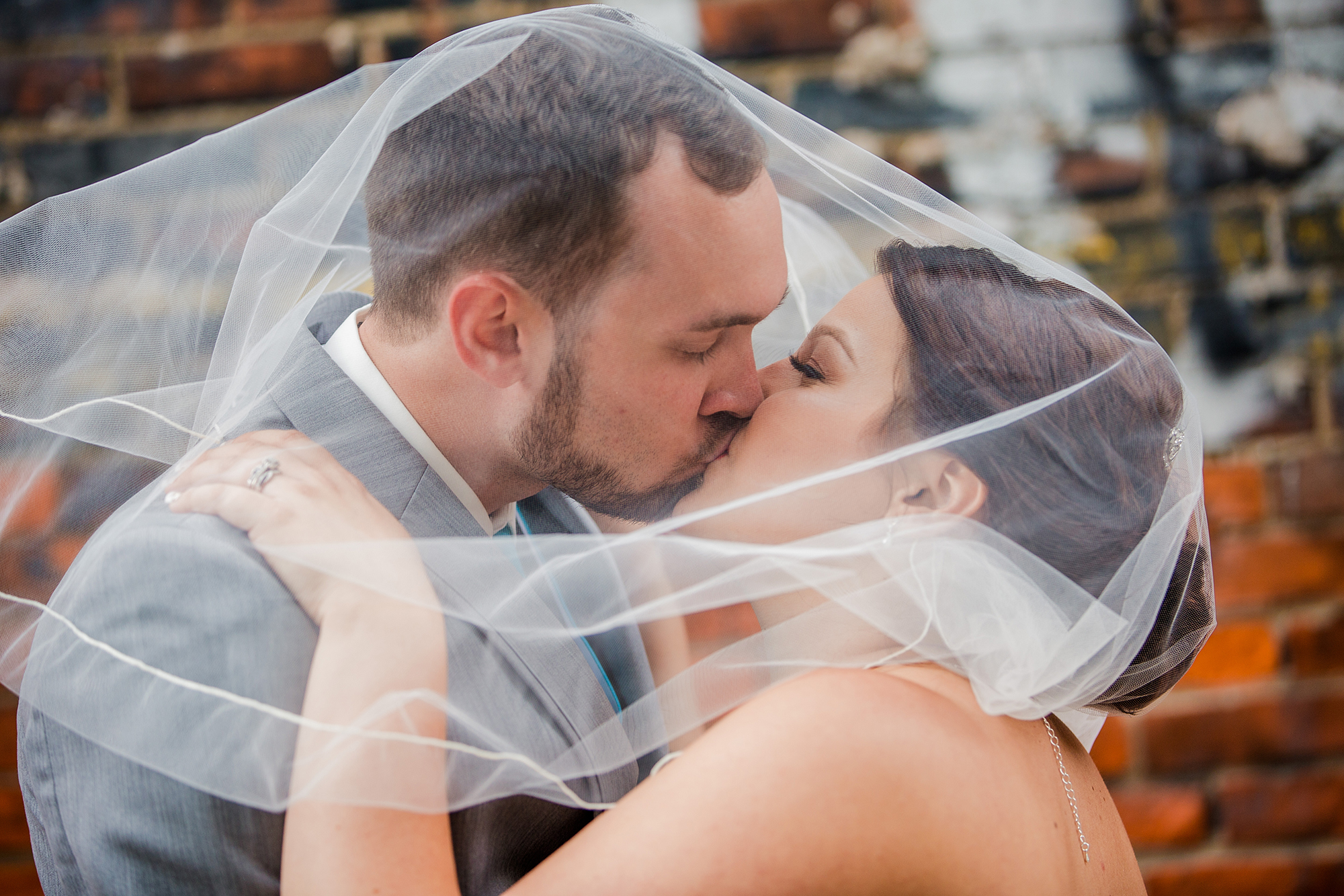 bride and groom kiss under her veil at Brewerie wedding in Erie PA