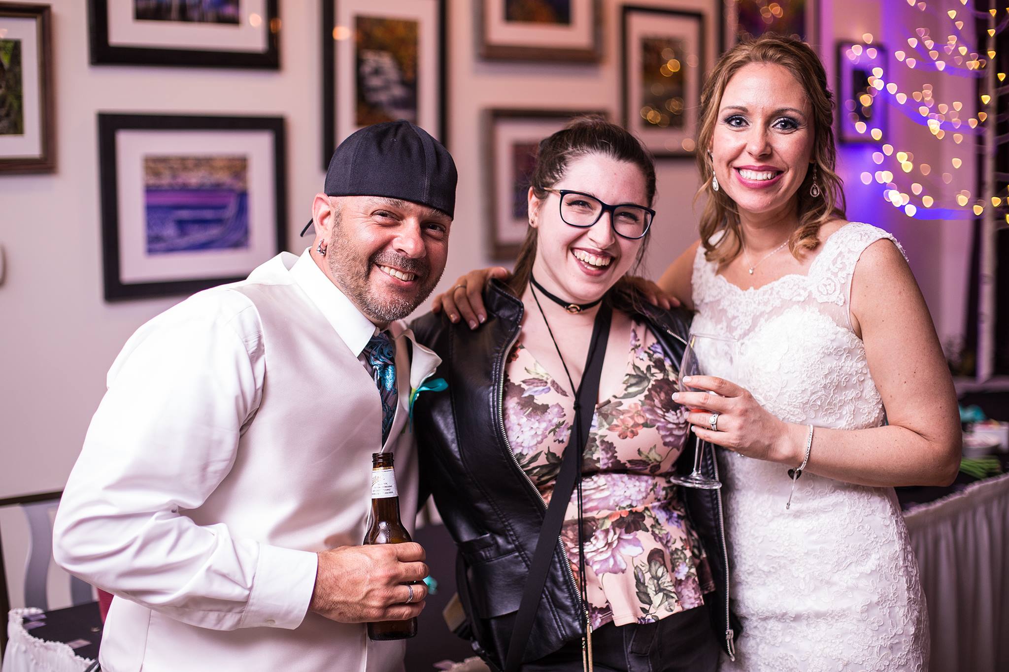 Erie PA second photographer poses with bride and groom at wedding reception