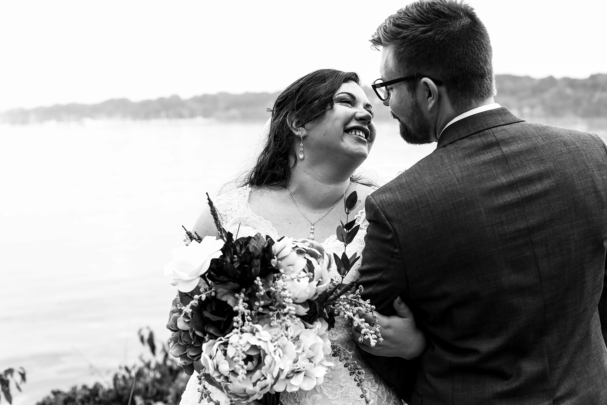 Erie, PA bride and groom smile at each other at Presque Isle State Park