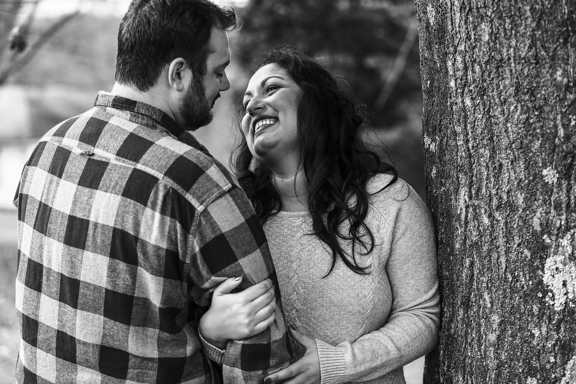 Woman looks loving at fiance during winter engagement photos