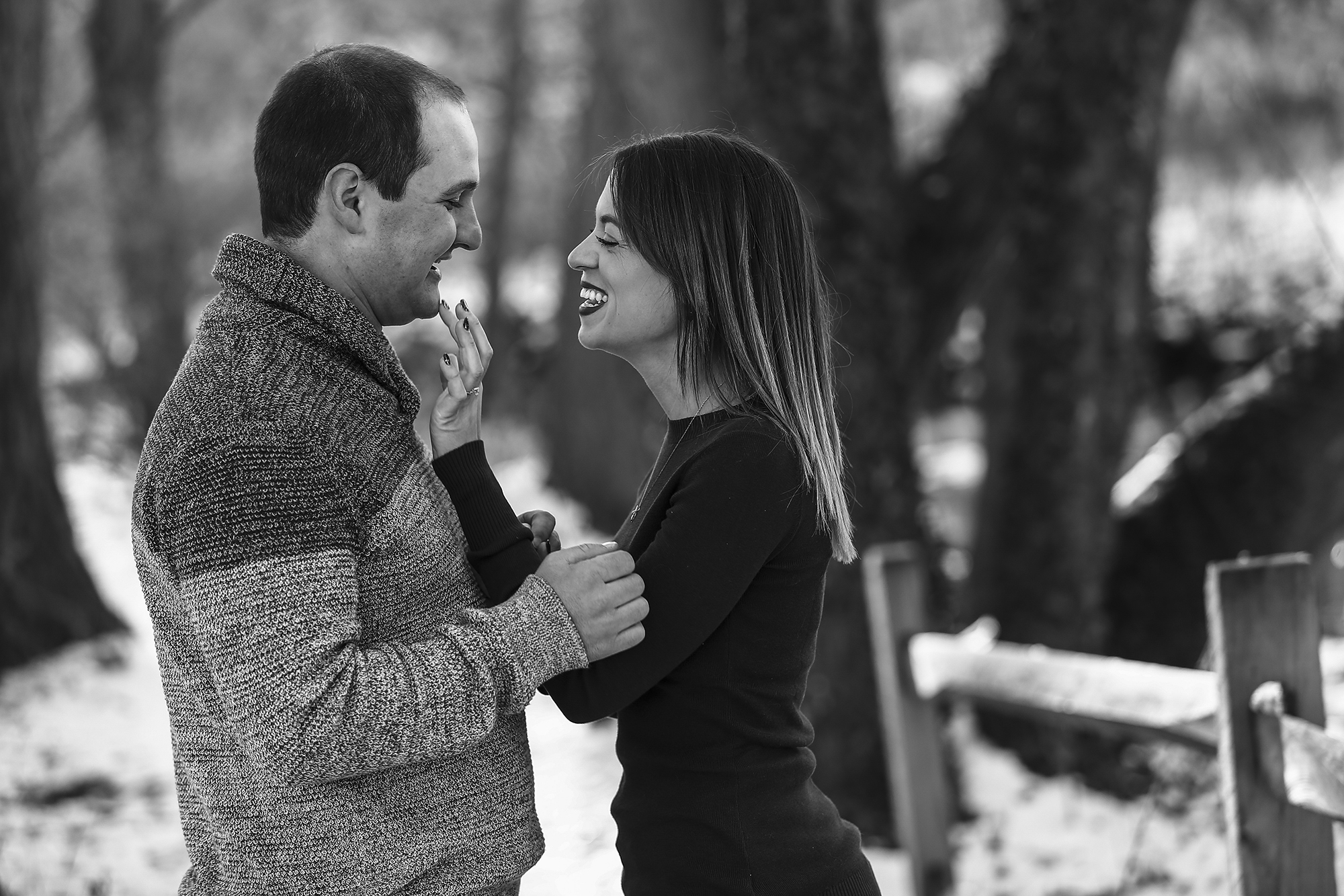 Woman wipes lipstick from fiance's face during Frontier Park engagement photo shoot