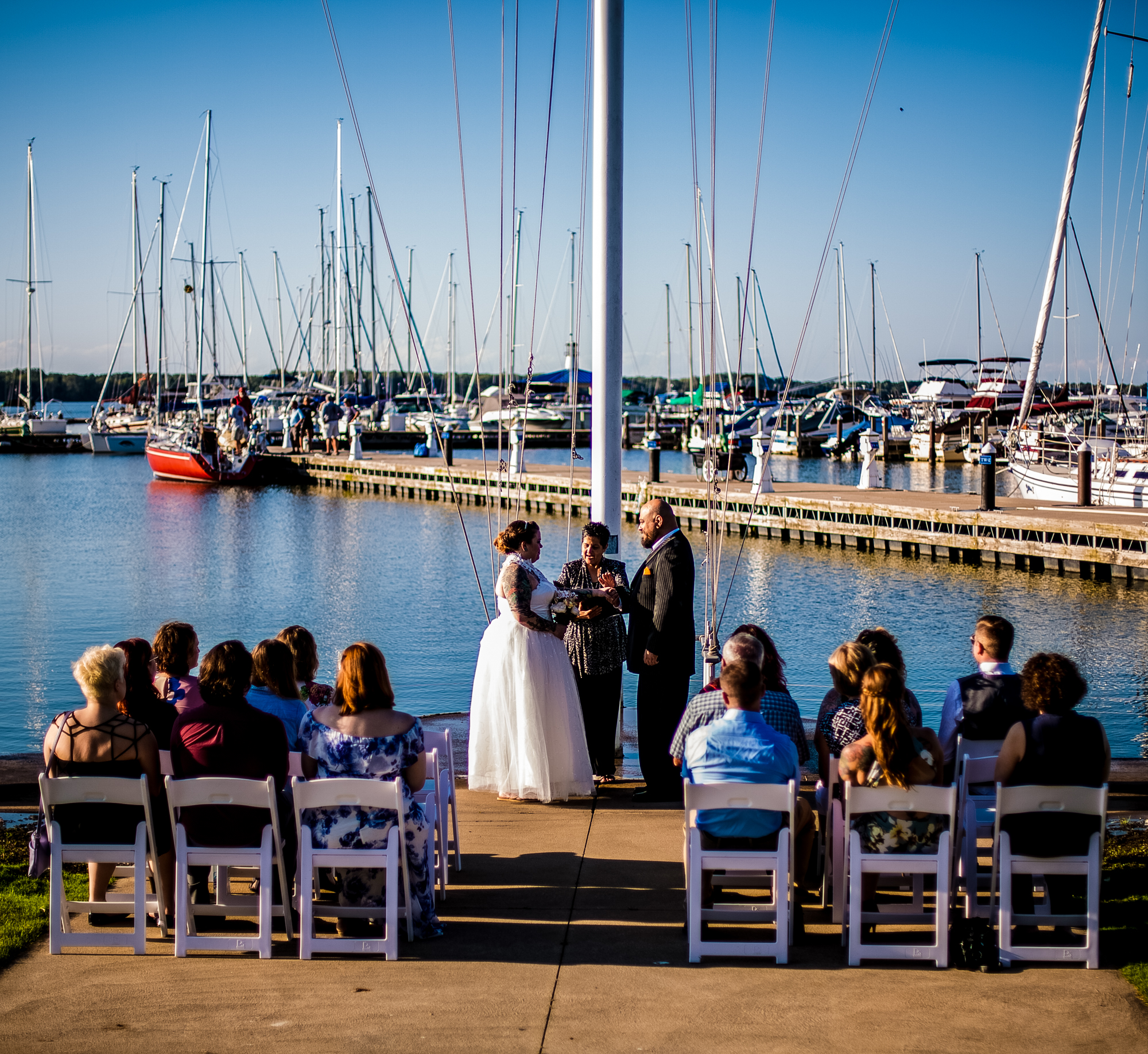 Wedding ceremony in front of the flagpole at the Erie Yacht Club