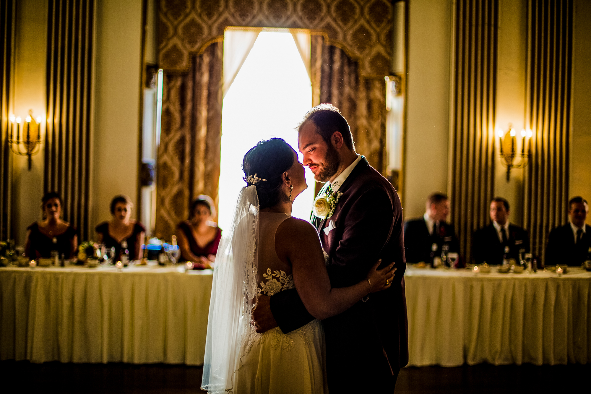 Couple framed by sunlight during first dance at George Washington Hotel