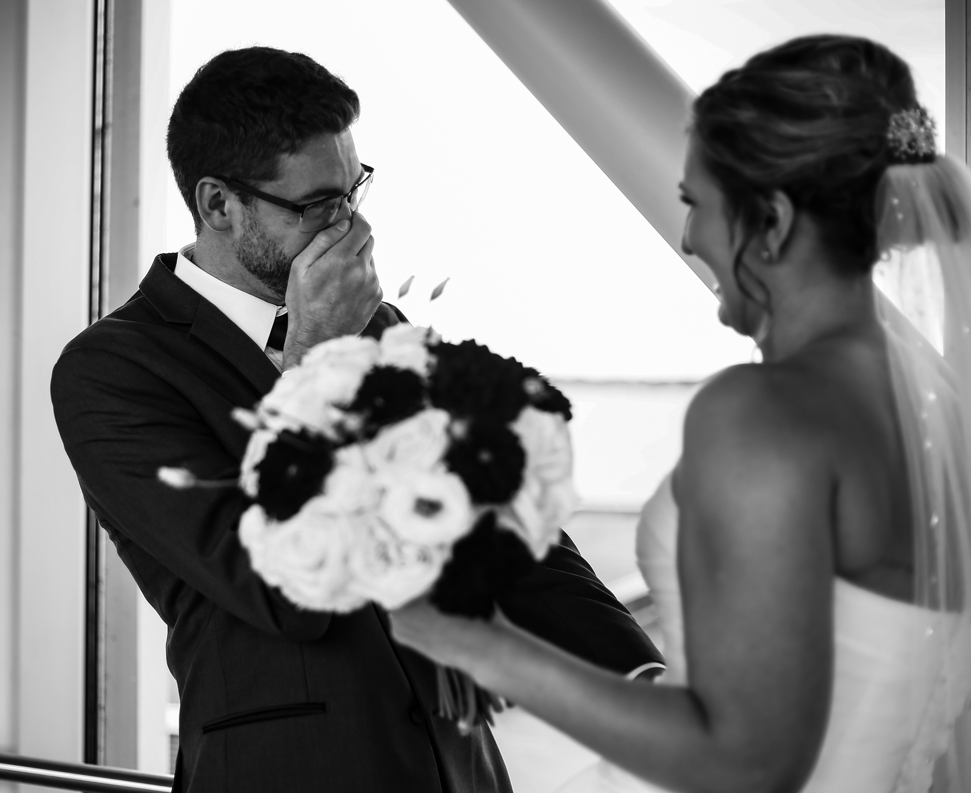 Groom reacts to seeing his bride during first look at Sheraton Erie Bayfront Hotel wedding