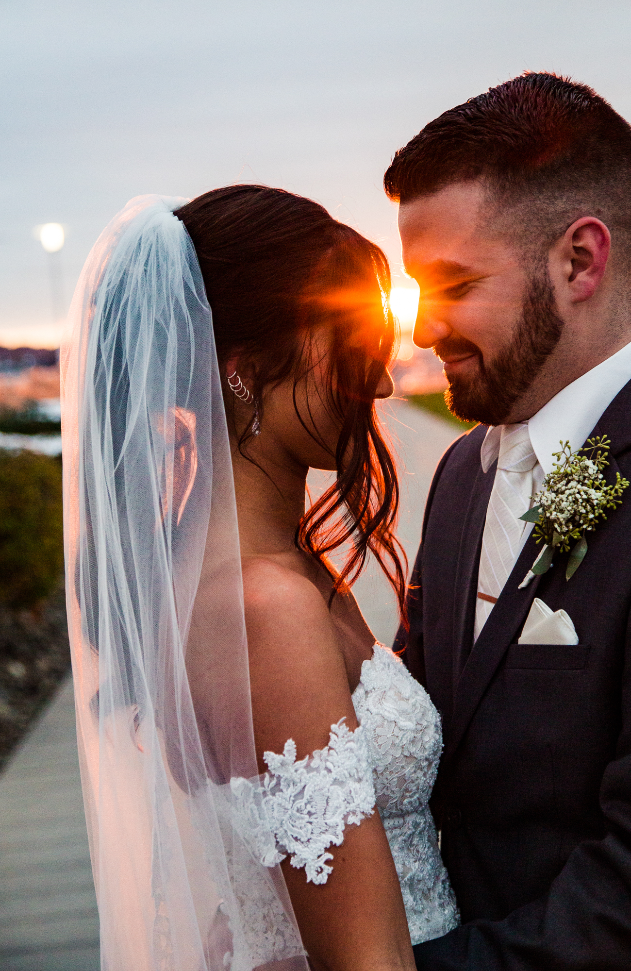 Bride and groom frame the light of sunset in downtown Erie wedding