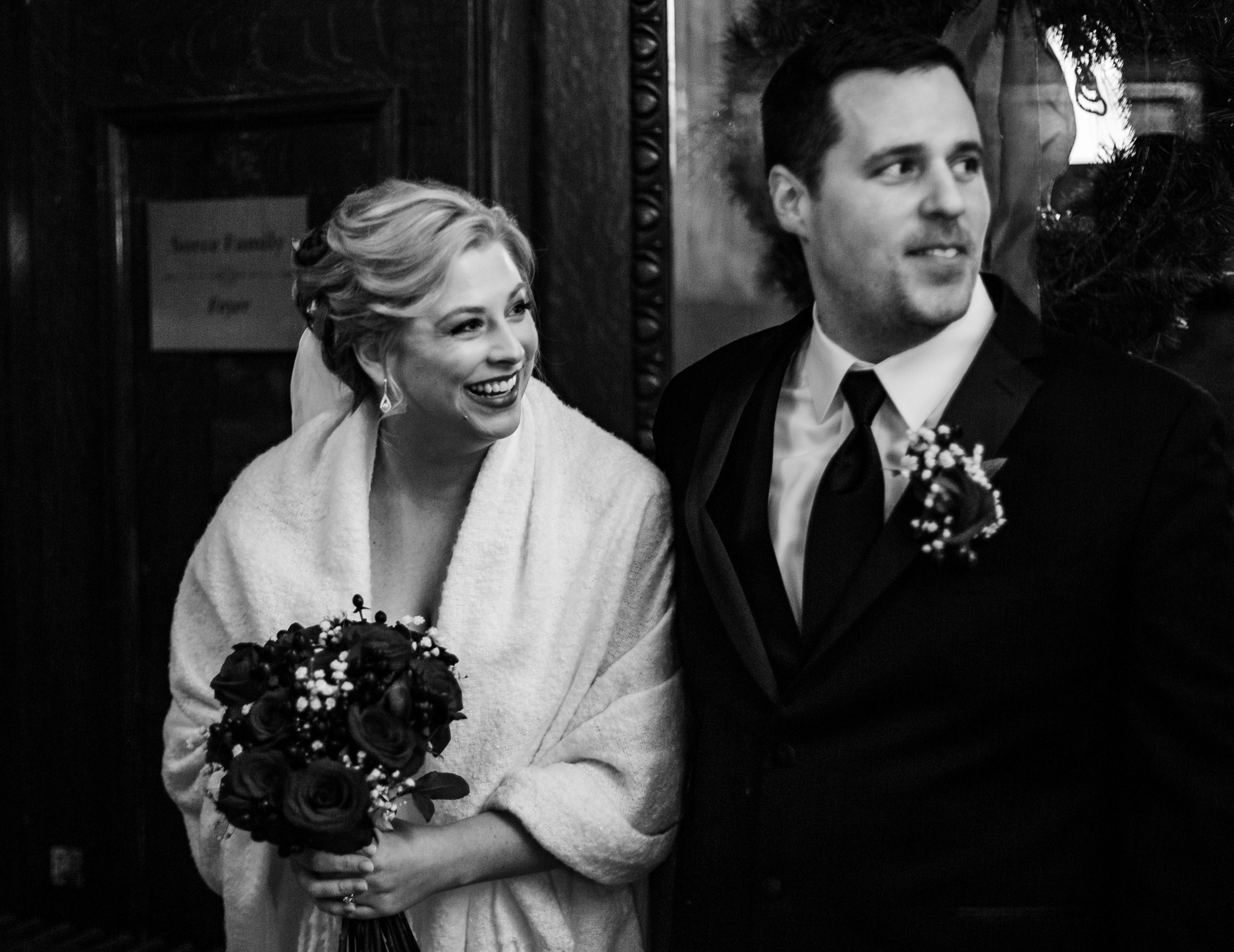 Bride and groom watch their guests during wedding at Watson Curtze Mansion in Erie, PA