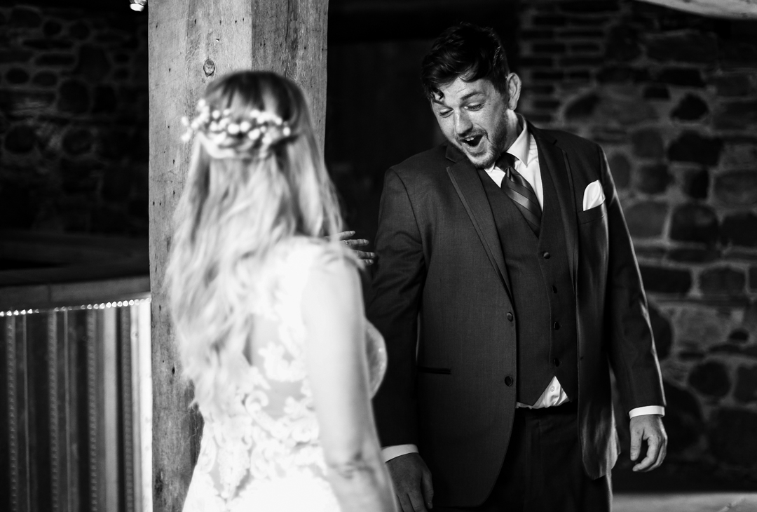Groom saying "WOW" when he sees bride during first look photos at Quincy Cellars