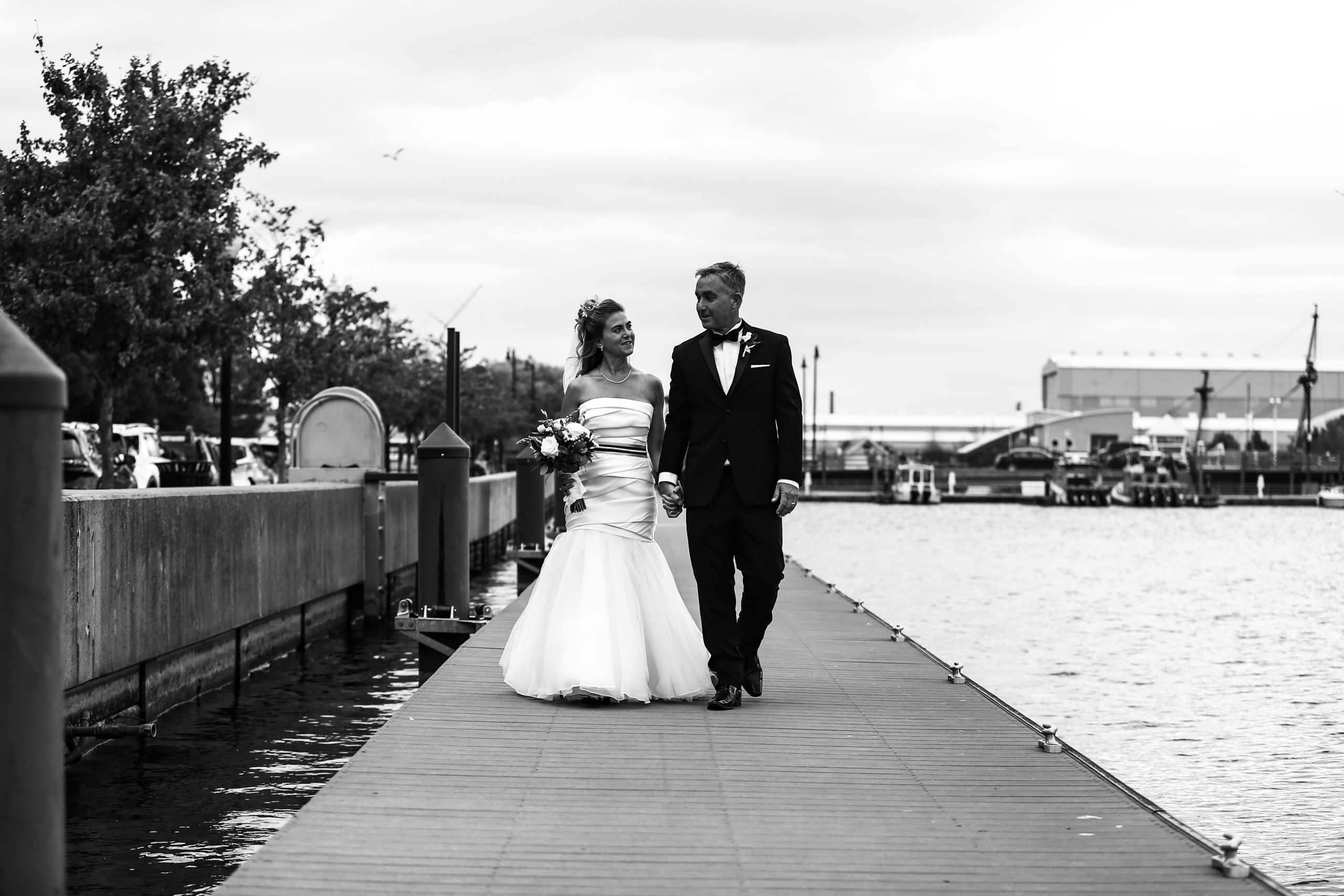 Bride and groom walk along the Bayfront in Erie, PA