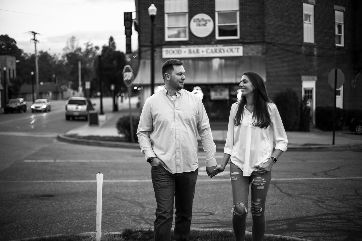 Couple smiles at each other while walking through downtown Edinboro