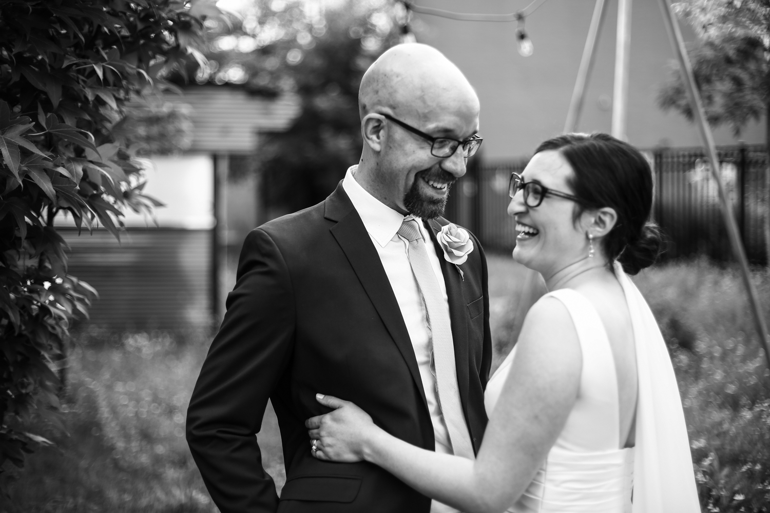 Couple laughing together outside the Erie Art Museum before their wedding