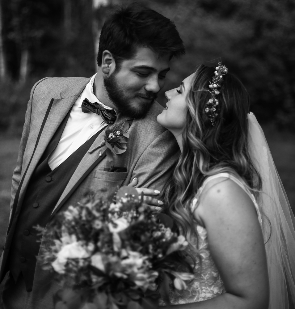 Bride and groom smiling at each other during Whispering Trees Manor wedding