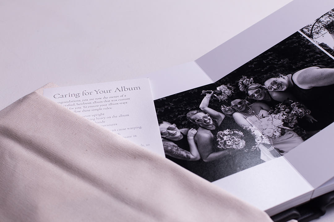 open wedding album sticking out of dust jacket with care instructions card