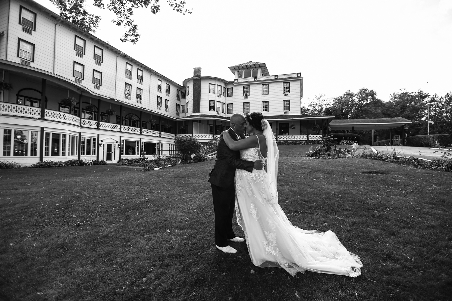 Bride and groom kiss outside the Hotel Conneaut