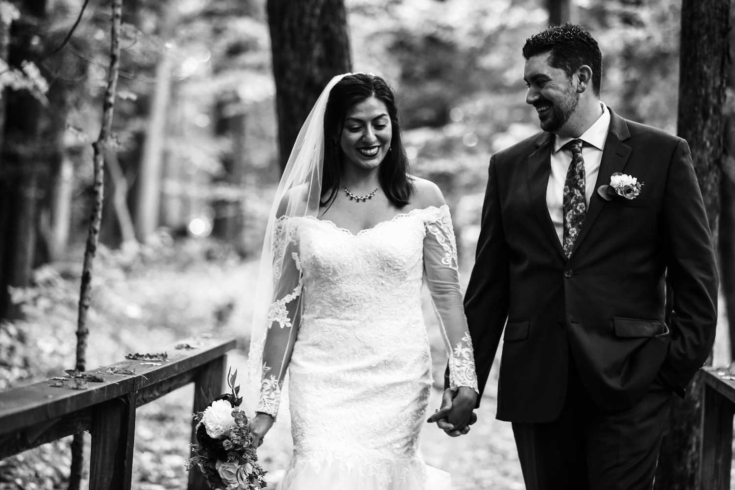 Bride and groom walk hand in hand for bridal portraits at their Headwaters Park wedding