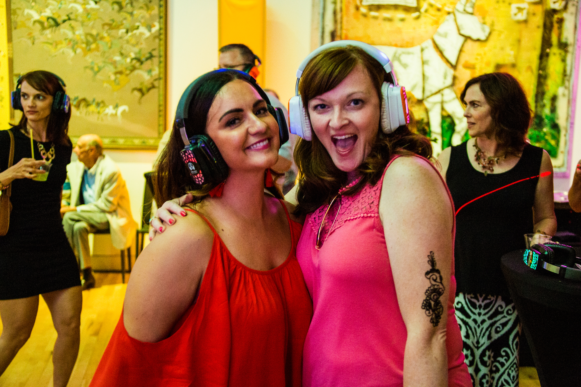 Two guests enjoying their own music at event with silent disco