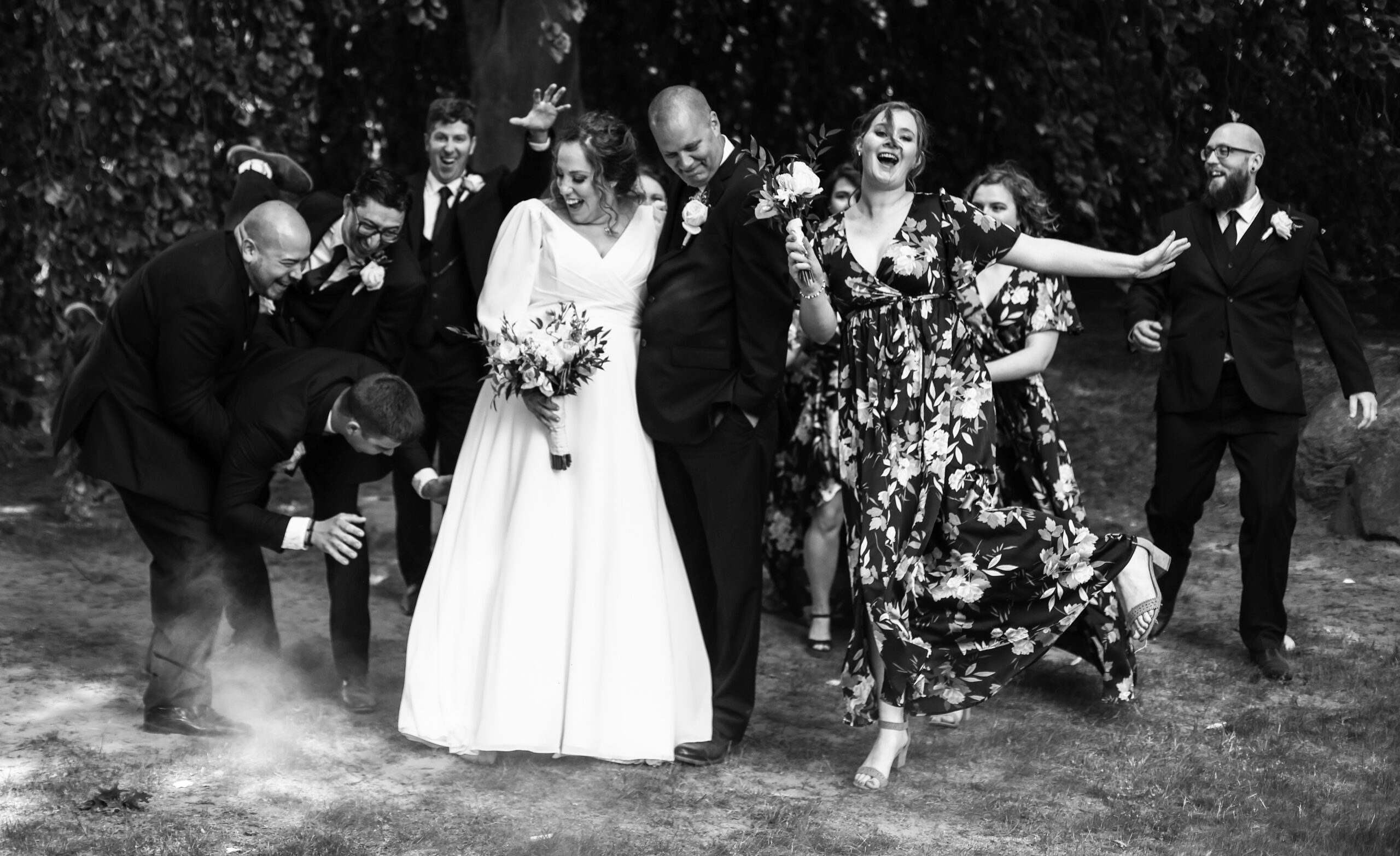 A wedding party laughing and acting silly for the photographer.